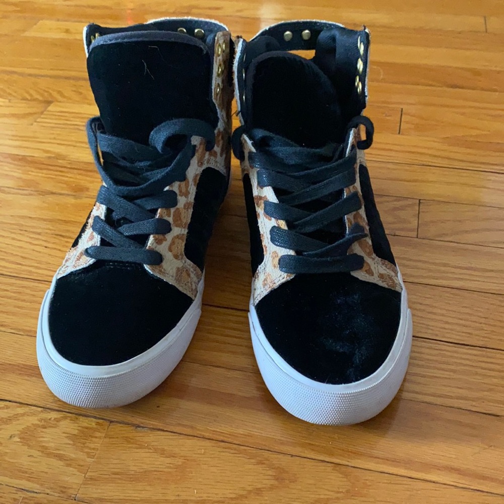 Black high tops with cheetah print.